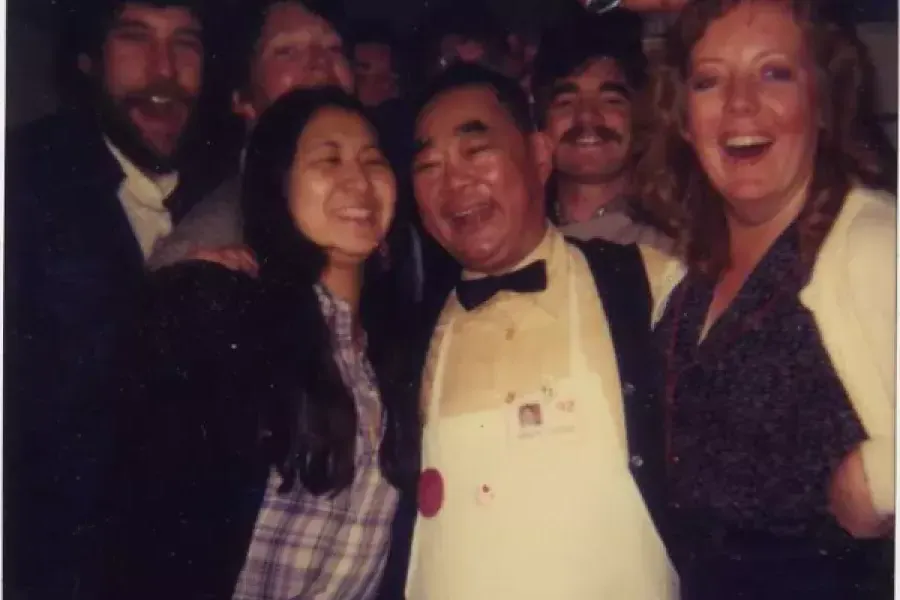 Edsel Ford Fung, the world's rudest waiter, poses at Sam Wo Restaurant with guests.